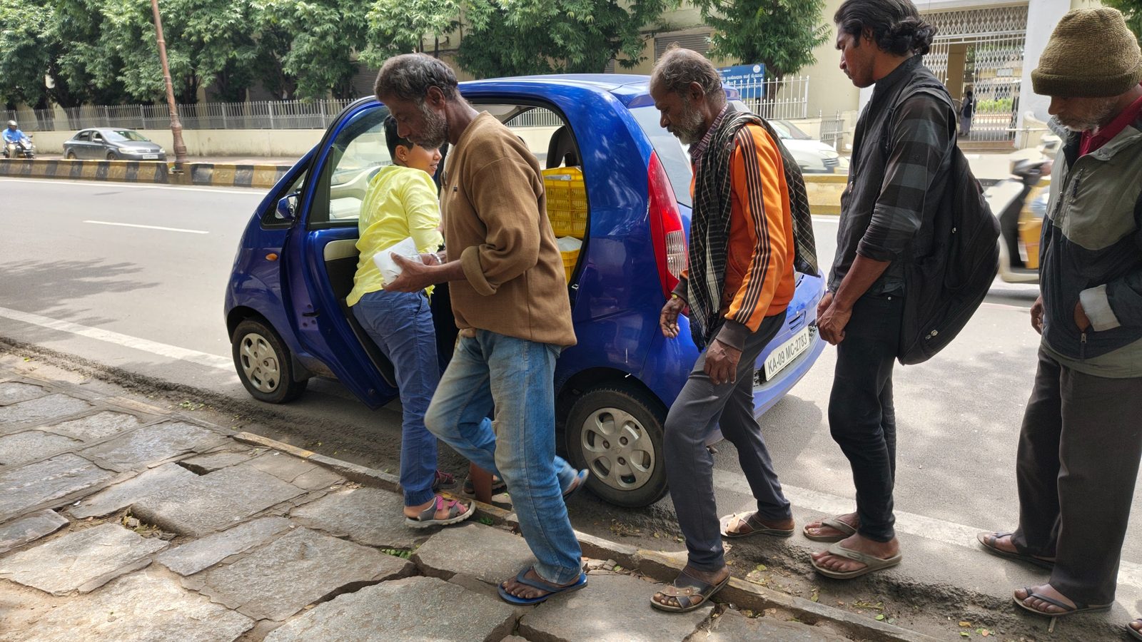 People receiving food packets near KR Hospital